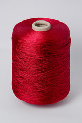 Green bobbin of yarn on a white background.Textile reel on isolated white background.