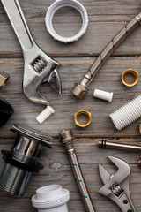 Plumbing layout. Tools and acessories on a wooden background