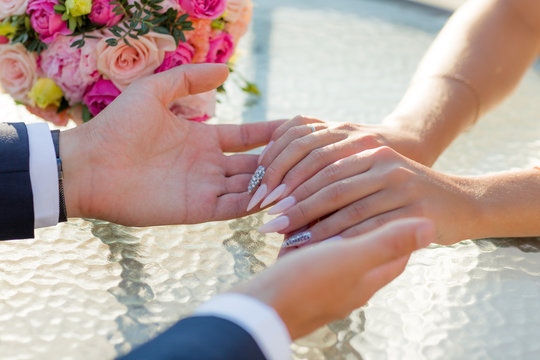 Picture of man and woman with wedding ring.Young married couple holding hands, ceremony wedding day. Newly wed couple's hands with wedding rings