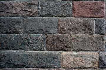 Dark vintage wall of heavy stone blocks