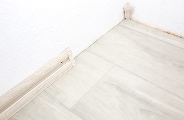 Baseboard installation. Repair works indoors. Renovation in the flat.