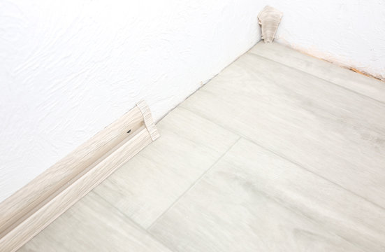 Baseboard Installation. Repair Works Indoors. Renovation In The Flat.