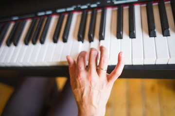 A woman learns to play the piano.
