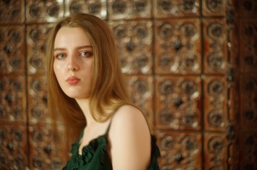 Fototapeta premium beautiful young blonde with long flowing hair and blue eyes in an old castle