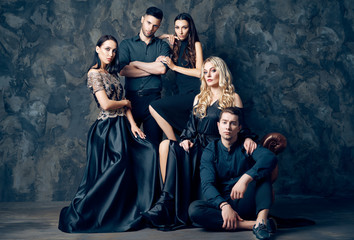 Group of young beautiful people posing in studio