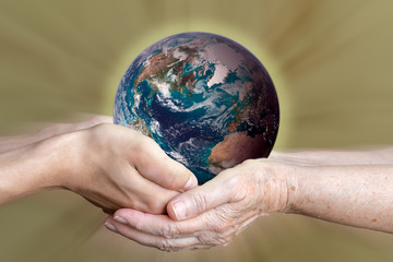 old and young person's hands holding planet earth, unity concept. elements of this images furnished by nasa