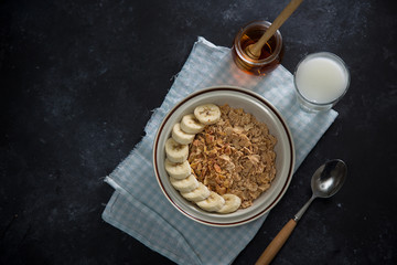 Tasty and healthy breakfast: fruits, corn flakes, milk and honey.