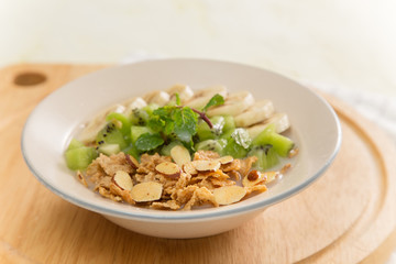 Healthy breakfast: corn flakes with milk and fresh fruits