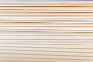 Closeup texture of stack of white books in geometric placement on white background. White abstract background. Copy space