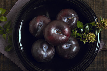 Close-up ripe plum fruit in a bowl