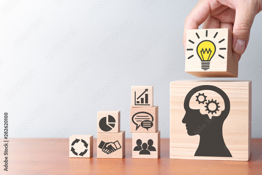 Poster business knowledge and lighting on solution. building wood blocks on table.