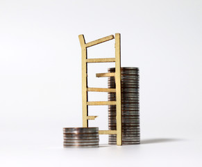 Miniature wood broken ladder and two pile of coins.  © Hyejin Kang