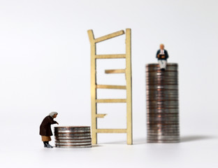 Miniature wood broken ladder and pile of coins with miniature people. © Hyejin Kang