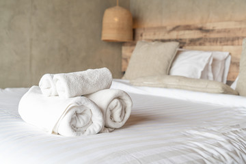 White towel on bed decoration in bedroom