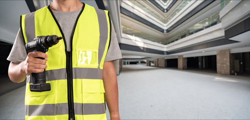 Construction Worker in front of construction site