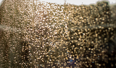 Glitter on glass from drops of water. Wet glass.