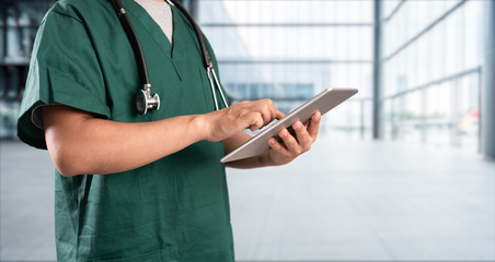 young doctor with hospital background