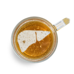 Sign human liver on the beer foam in glass isolated on white background. Top view. Harm of alcohol concept