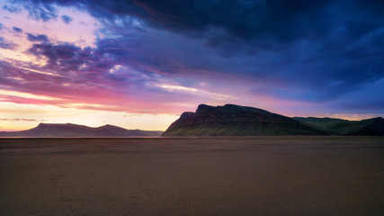 Fototapeta na wymiar Sandy beach at sunset beautiful mountain rainbow colors