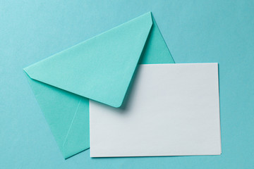 Green envelope and blank letter on green background. Template with place for text on postcard....