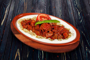 juicy, fried, tender steak with vegetables and sauces on a special stand