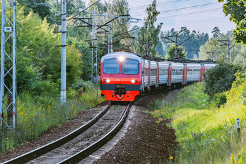 Naklejka premium Passenger train moves through countryside, Moscow region. Russia.