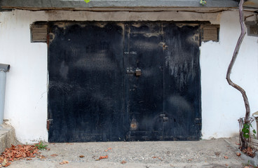 old metal door to the car garage