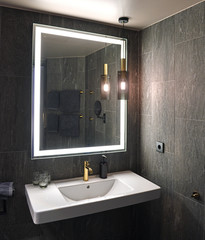 Bathroom interior with white sink and mirror
