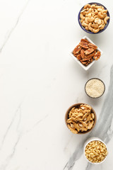 Frame made of different types of nuts in bowls