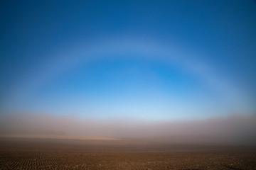 white rainbow on the hill