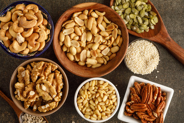 Close-up view of different types of nuts in bowls