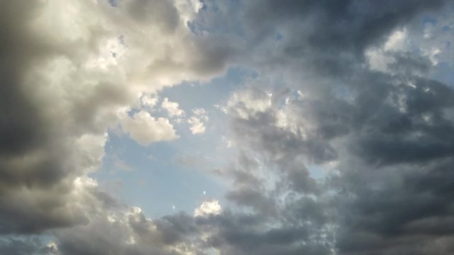 Awesome 4K timelapse of banks of clouds with light effects and scenic movement in the air