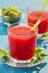Cold fresh watermelon juice on a wooden blue table.