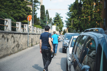 photographers walking along street