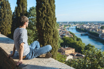 Fototapeta na wymiar young man looking at city and river