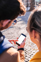 Picture of young couple using phone to find way