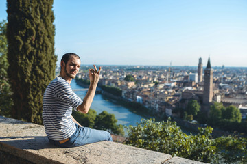 Fototapeta na wymiar young man showing italian gesture