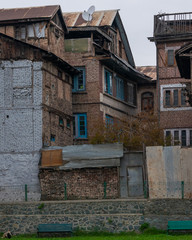 Fototapeta na wymiar Abandoned building in old town Srinagar, Jammu and Kashmir, India. Ancient architecture buildings wooden window and the old brick wall houses at Srinagar is travel attraction