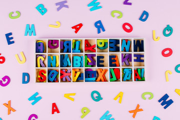 Colorful Letters Falling Inside A Wooden Box. Back to school concept. Flat lay, top view