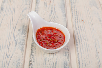 beautiful and juicy sauce seasoning for various dishes on a wooden substrate, for decoration in food design and cooking