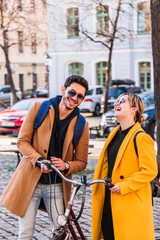 Young hispanic man tells something funny to girl