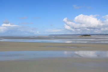 Tombelaine rock and Carolles Champeaux cliffs in the background in colorful Mont Saint Michel bay - UNESCO world heritage, Normandy, France