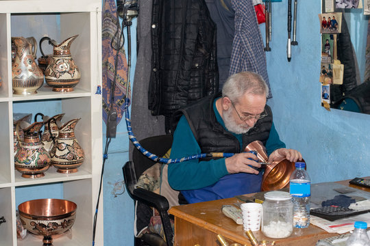 Coppersmith is working in his shop in Suleymaniye, Istanbul. Copper working in Suleymaniye is a traditional craft and dates back to several hundreds years ago.