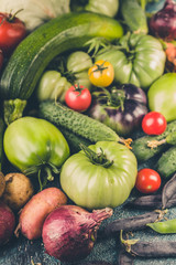 Autumn harvest. Fresh vegetables: Tomatoes, zucchini, potatoes, onions, carrots, beans and peas. Farm Organic Food. Vertical shot