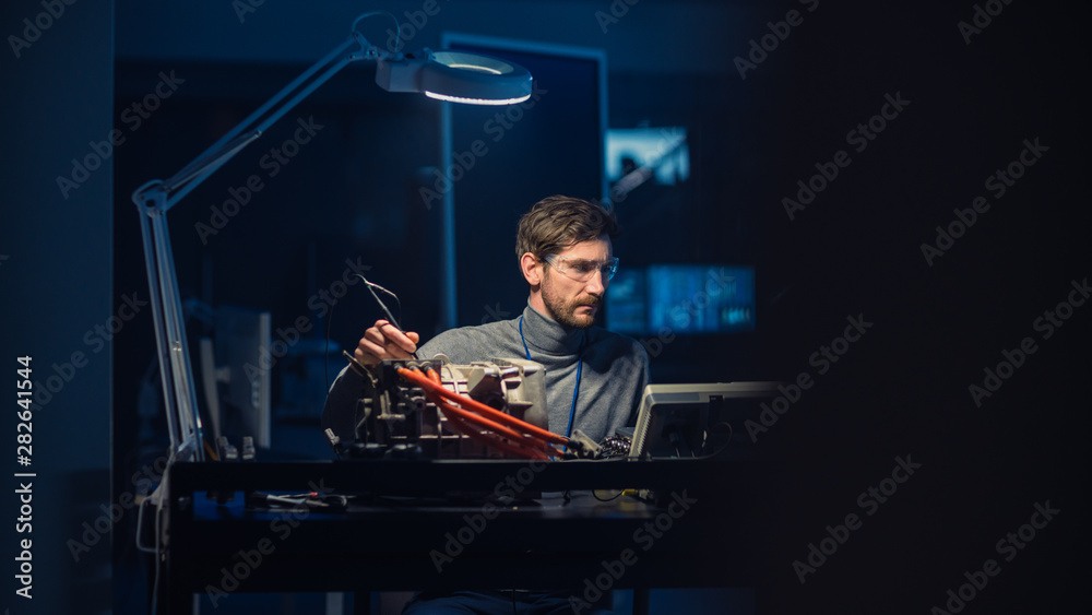 Aufkleber professional automotive engineer in glasses and inspection tools is testing an used electric engine 