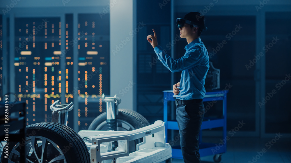Aufkleber automotive engineer working on electric car chassis platform, using augmented reality headset with t