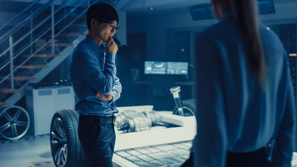 Automotive Design Engineers Working on Electric Car Chassis Prototype. In Innovation Laboratory...