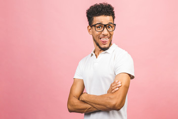 A young smiling happy funny African American male isolated against pink background.