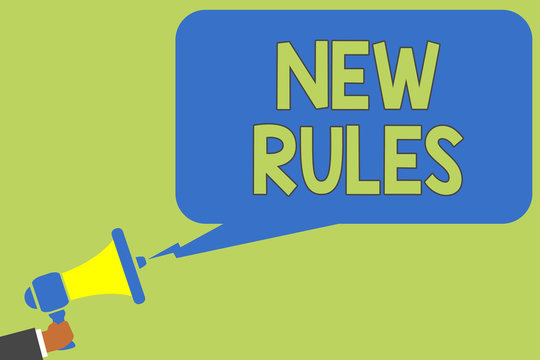 Text sign showing New Rules. Conceptual photo A state of changing an iplemented policy for better upgrade Man holding megaphone loudspeaker speech bubble message speaking loud