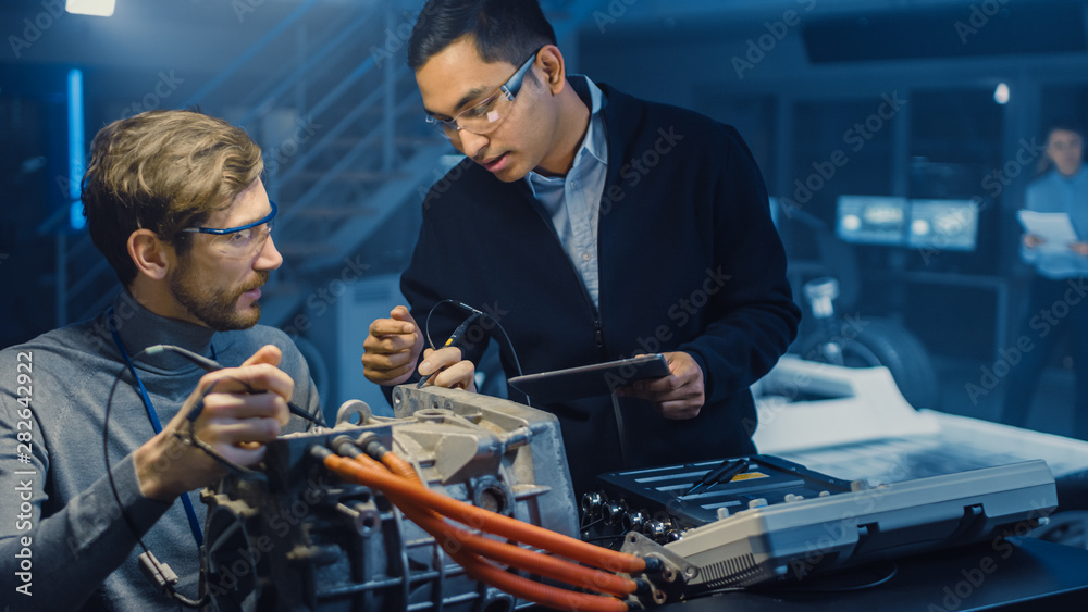 Leinwandbilder two professional automotive engineers with a tablet computer and inspection tools are having a conve